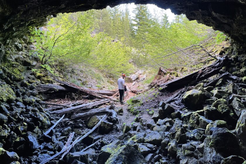 Photo of Evan exiting an unnamed cave in the Big Lava Trench.